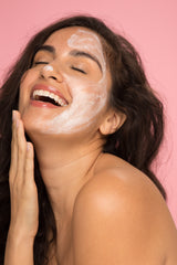Woman applying Vasanti 4-Step Skincare Travel Kit on half of her face